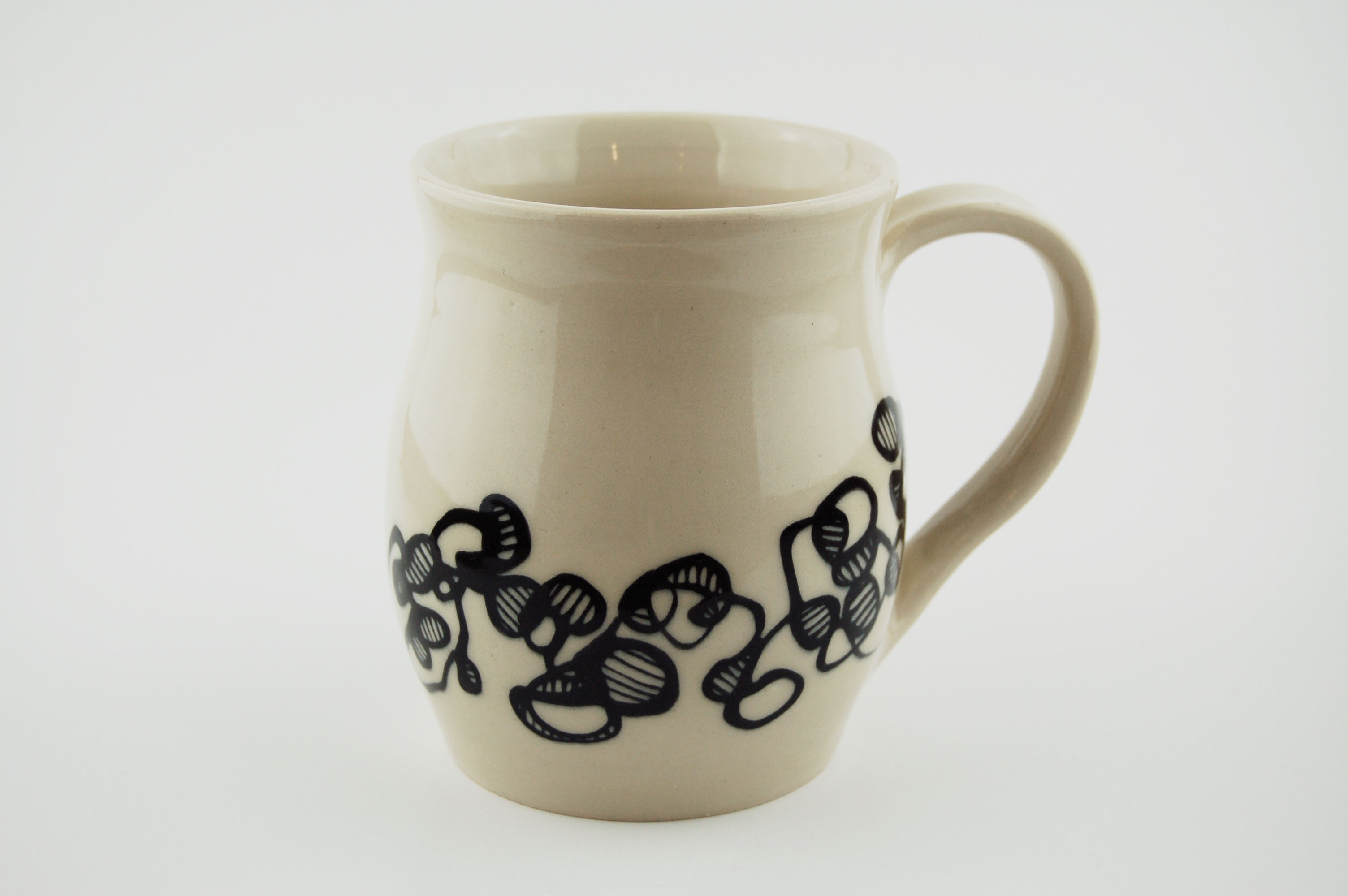 Ceramic mug with black lines on off-white clay