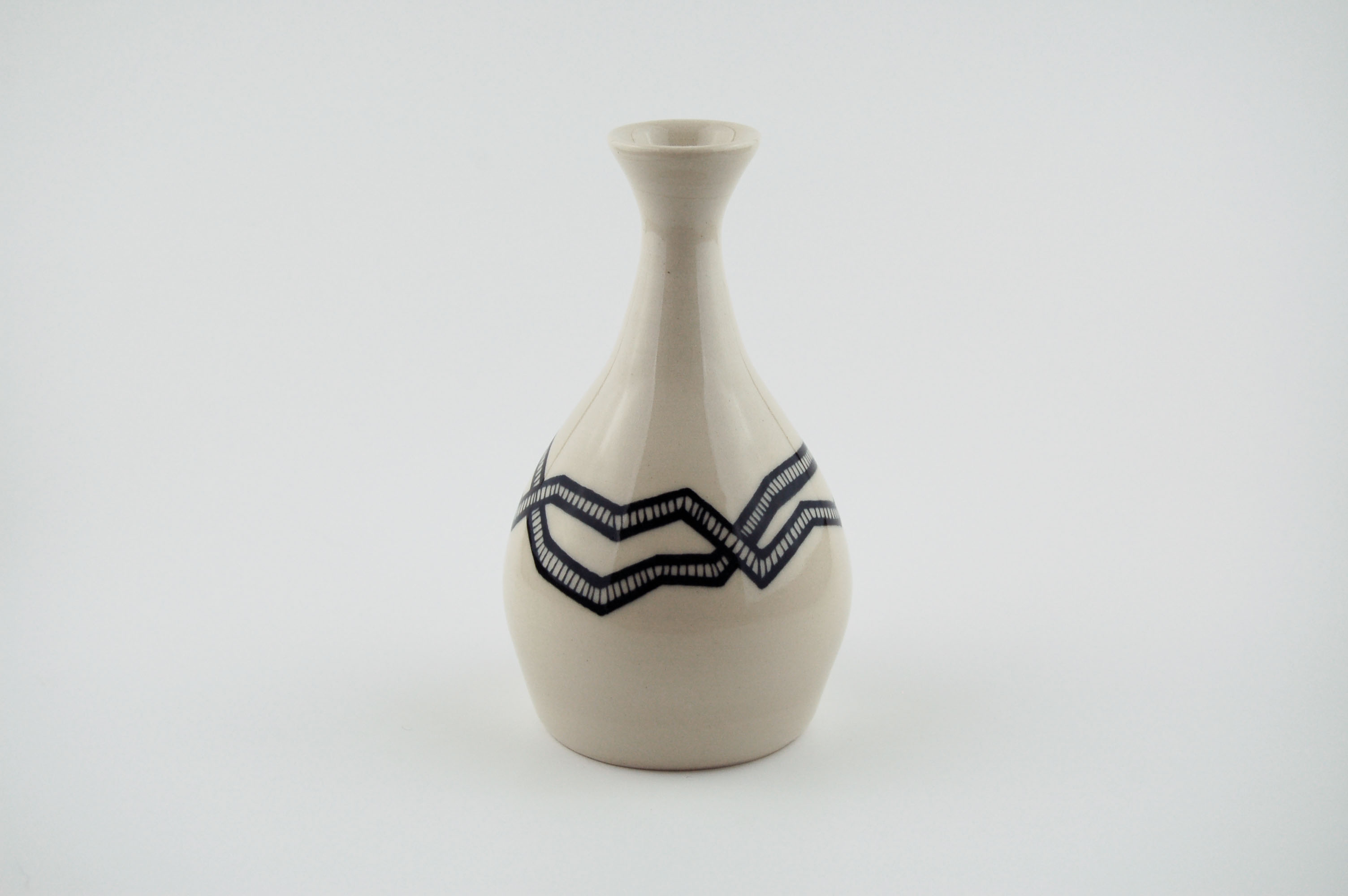 Ceramic vase with black lines on off-white clay