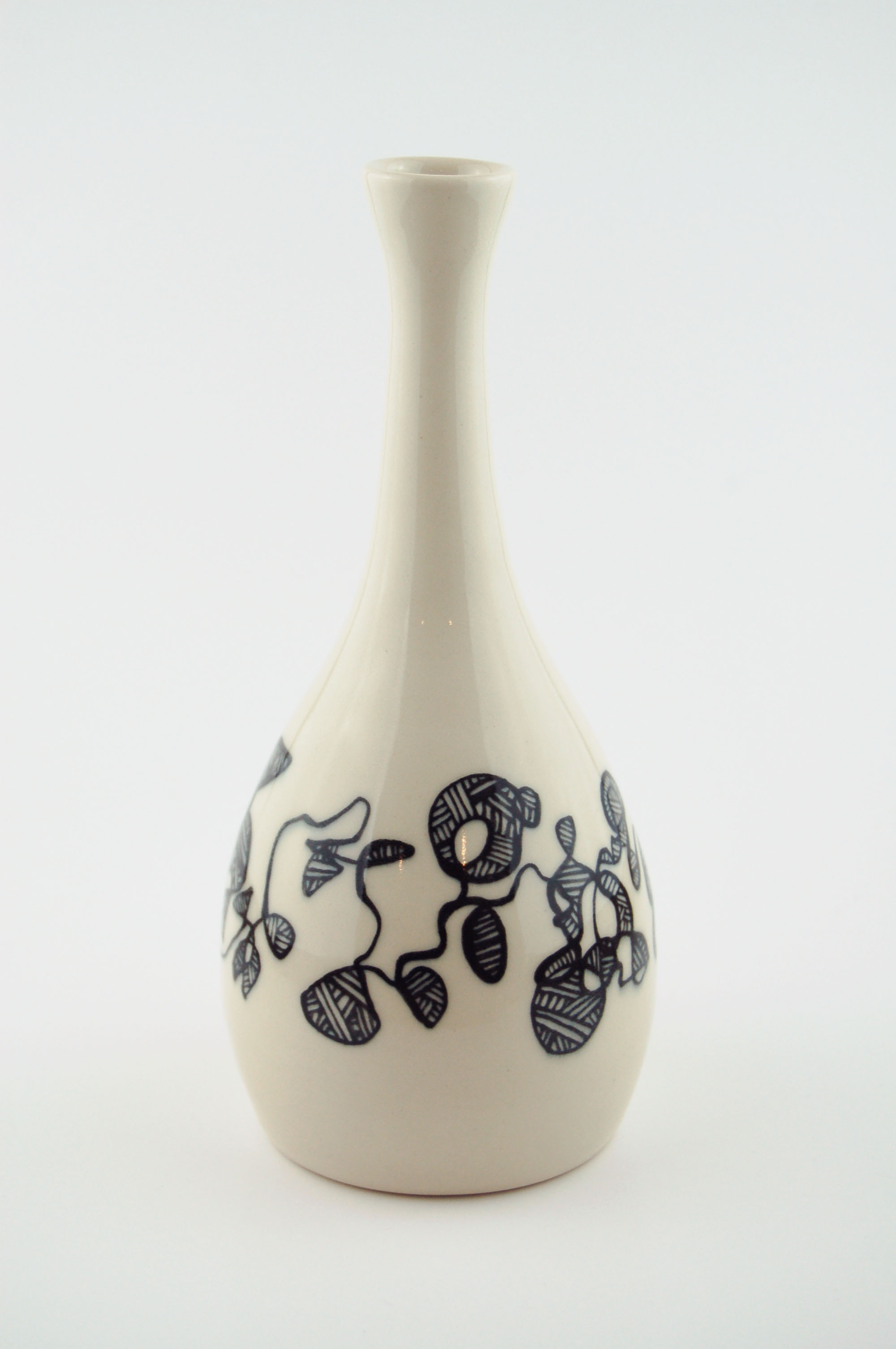 Ceramic vase with black lines on off-white clay