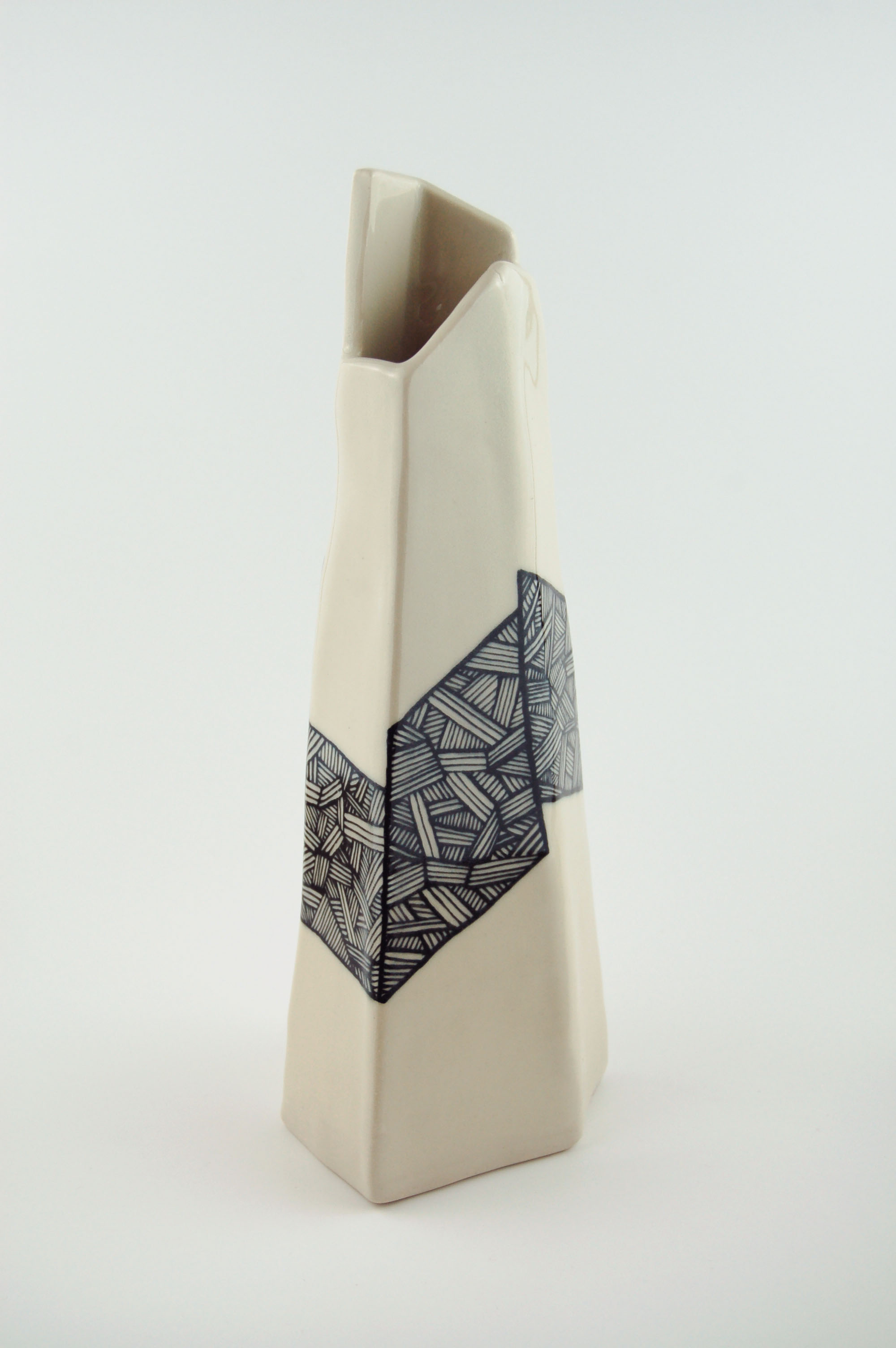 Ceramic vase with black lines on off-white clay