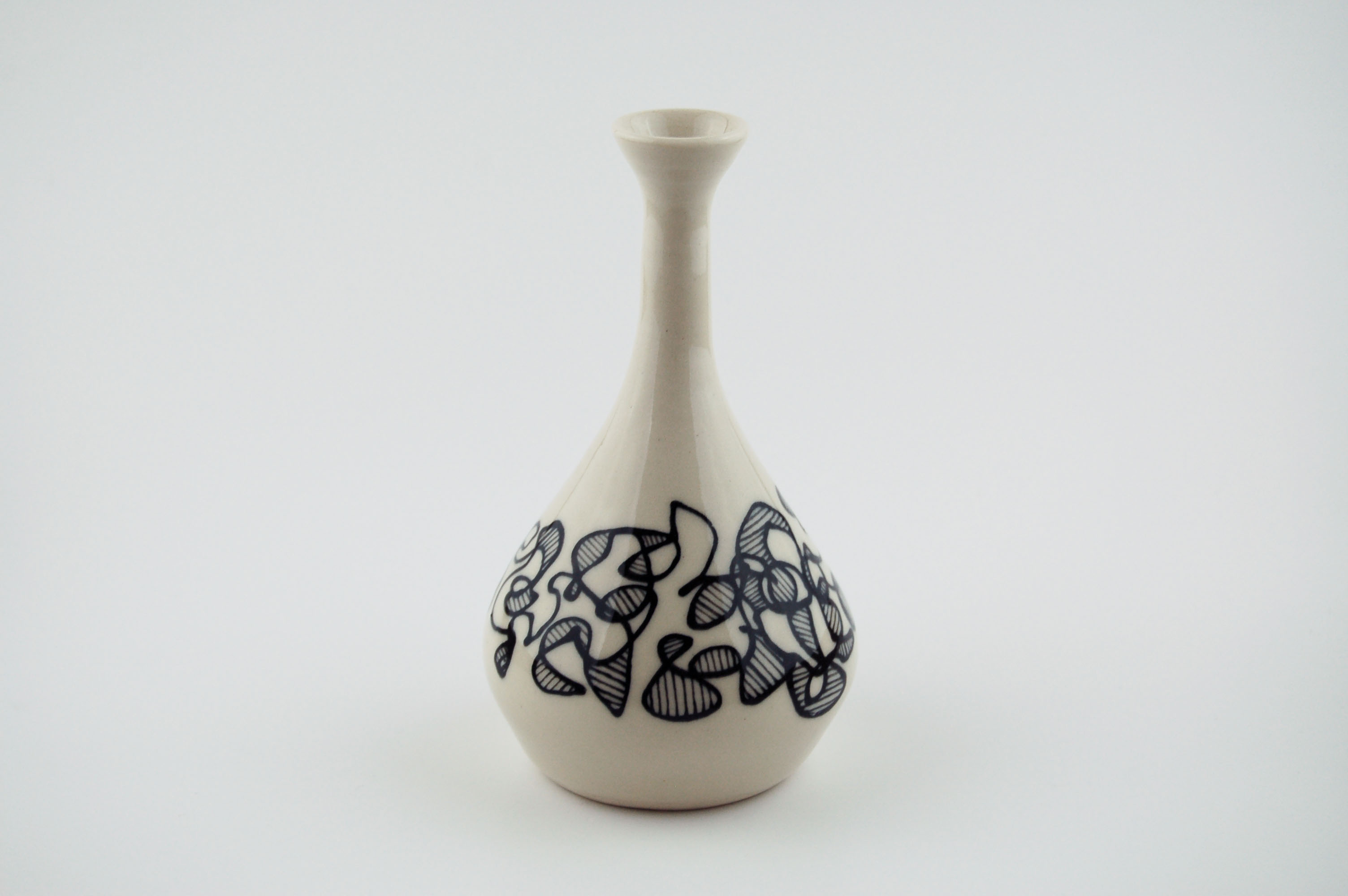 Ceramic vase with black lines on off-white clay